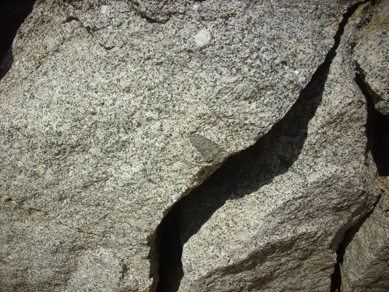 A close view of coarse-grained granite split by a deep crack